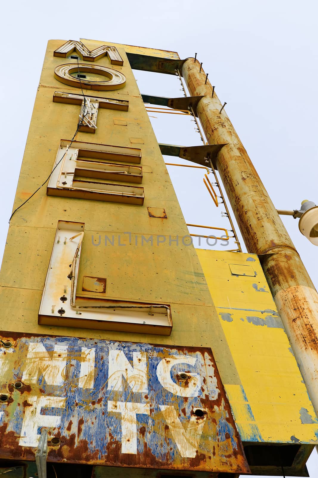 Old Motel sign ruin along historic Route 66 in the middle of California vast Mojave desert.