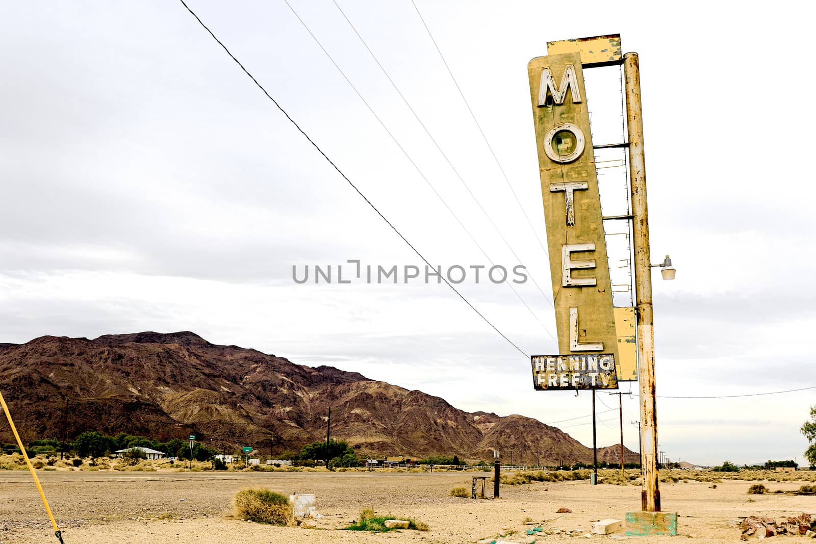 Old Motel sign ruin along historic Route 66 in the middle of California vast Mojave desert.