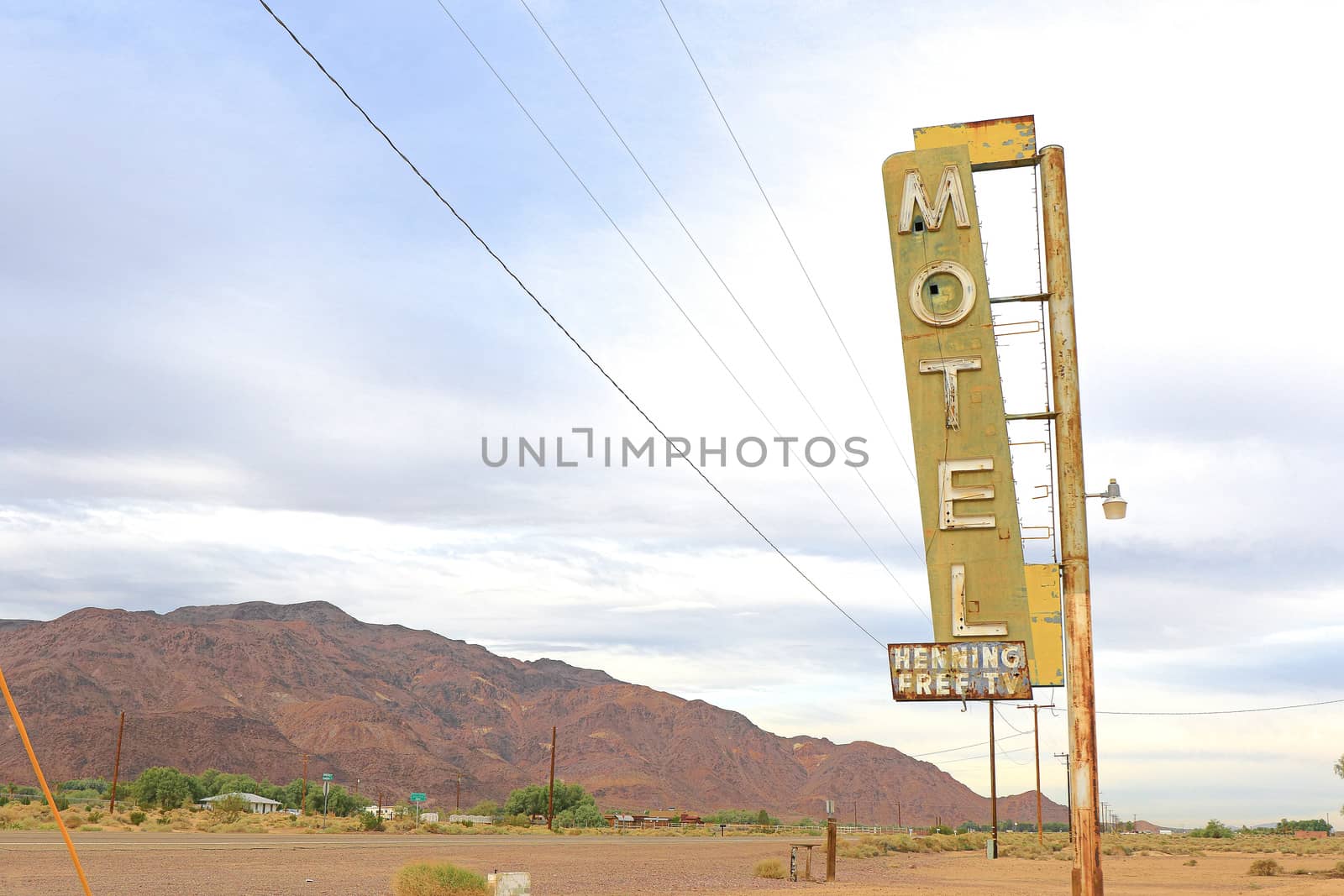 Old Motel sign ruin along historic Route 66 in the middle of California vast Mojave desert.