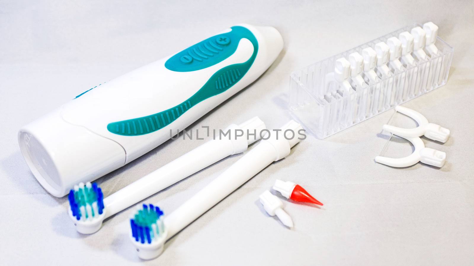 Electronic toothbrush with toothbrush heads white color background