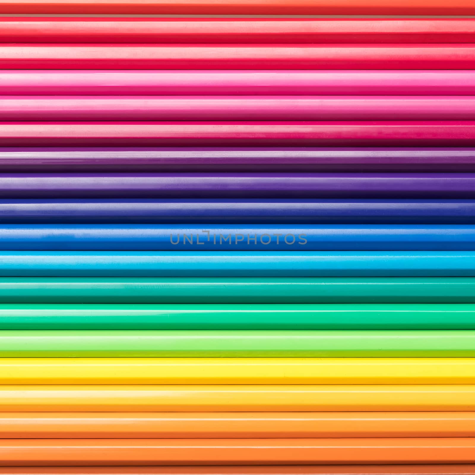 Close-up of a group of pencils arranged according to the light spectrum. Colorful background.