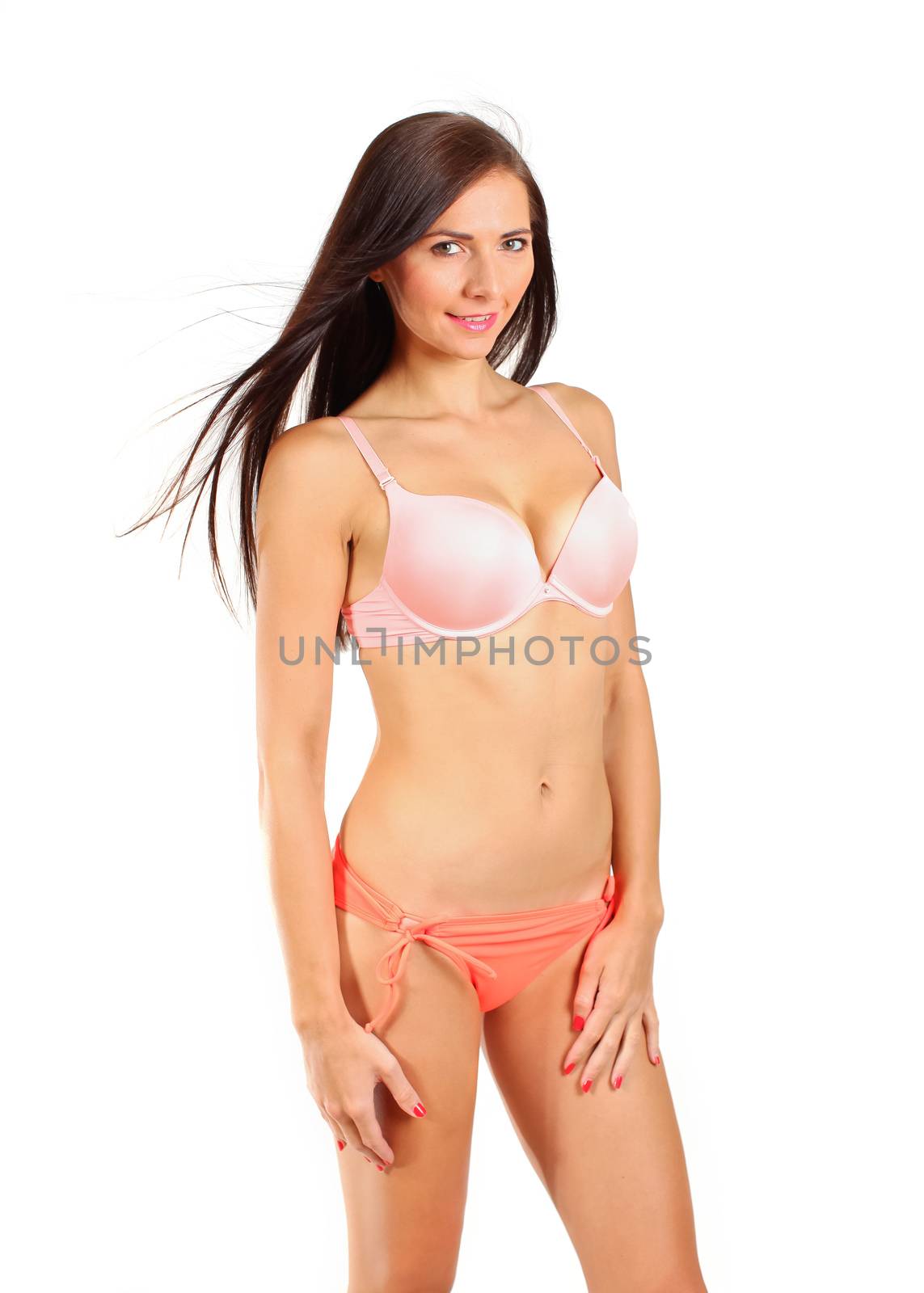 Young brunette woman in bikini underwear isolated on white backg by Ivanko