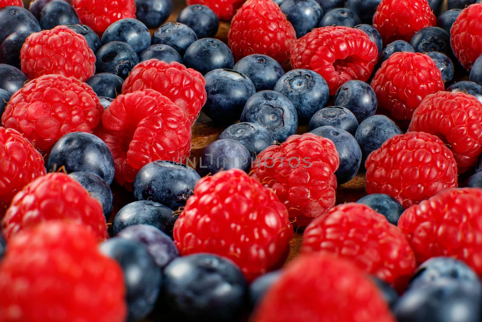 Closeup shot of mixed blueberries and raspberries. by Ivanko