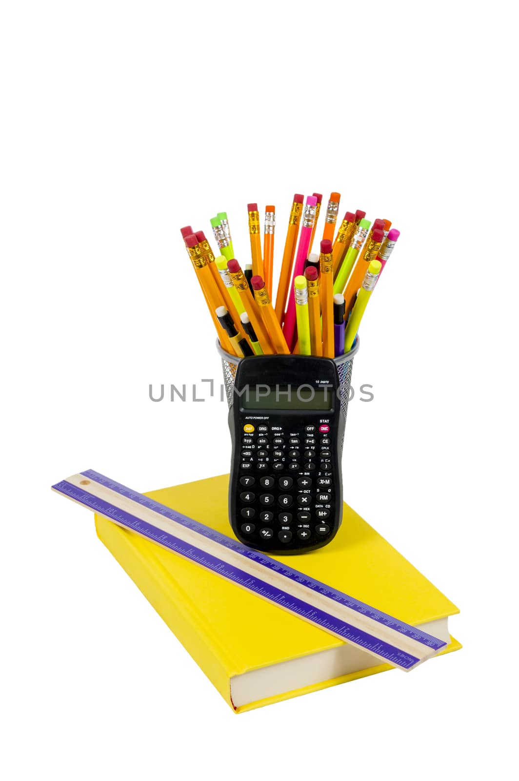 Vertical shot of brightly colored book, ruler, calculator and pencils in holder.