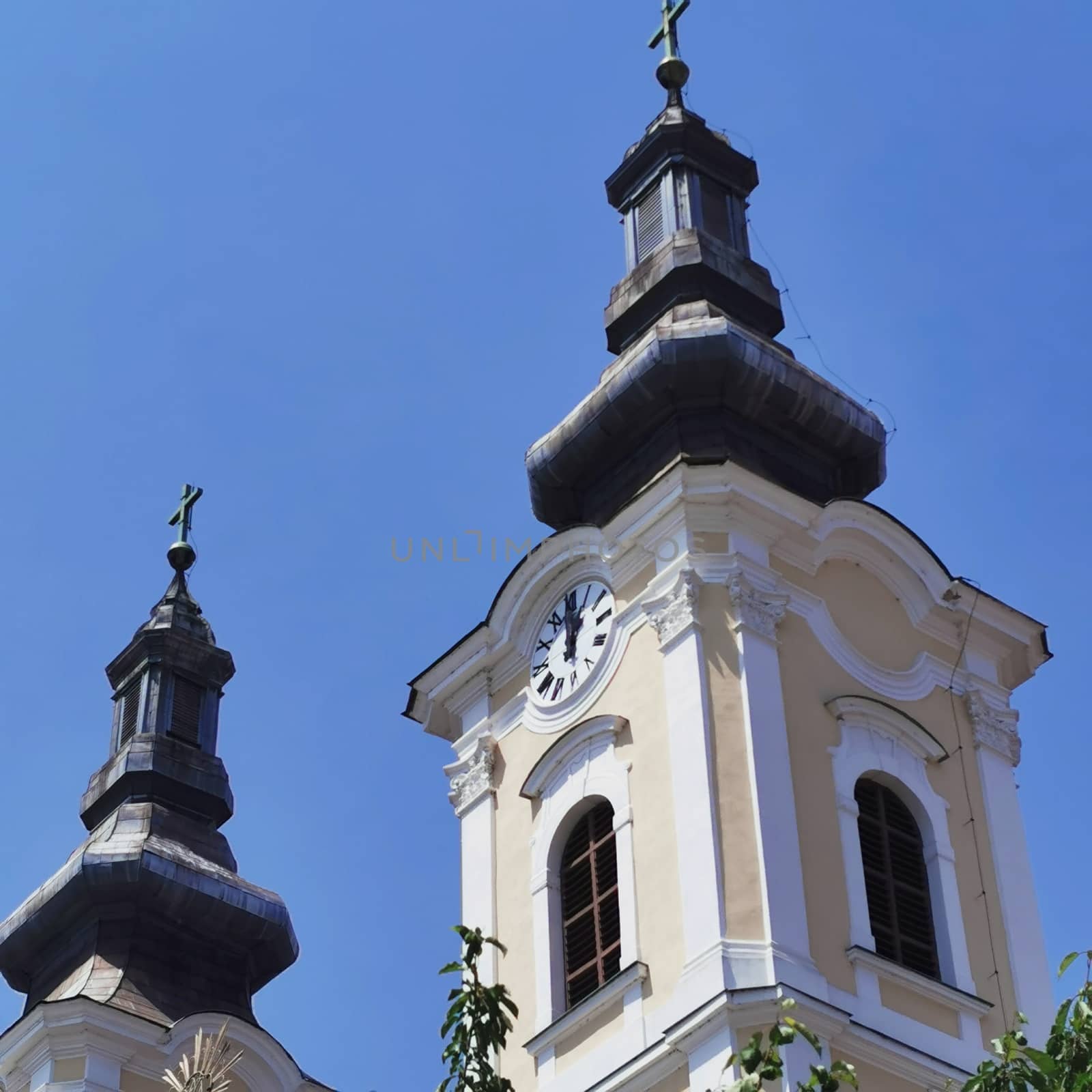 The church in Miskolc is close up with the beautiful large number plate clock. High quality photo