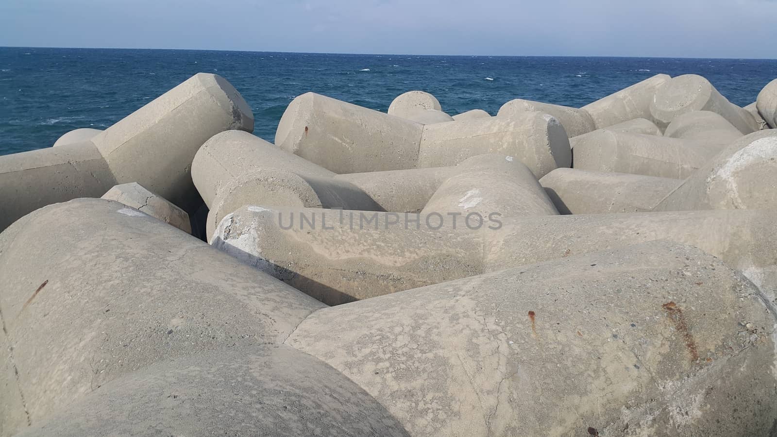 Close view of tetrapod stones on the sea shore to prevent coastal ersosion. Break water concrete tetrapods.