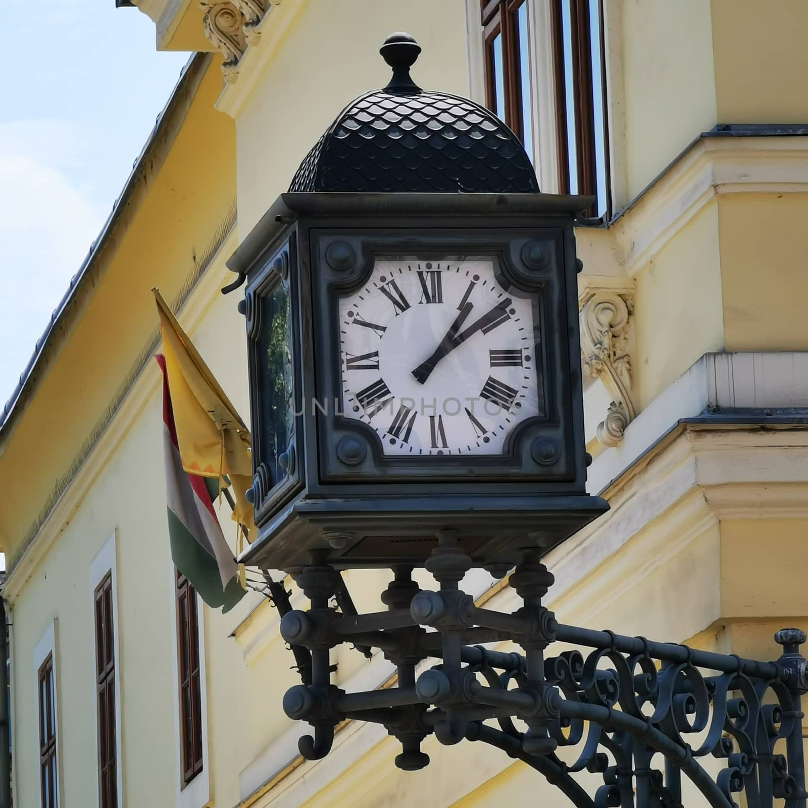 A clock on the side of a building. High quality photo