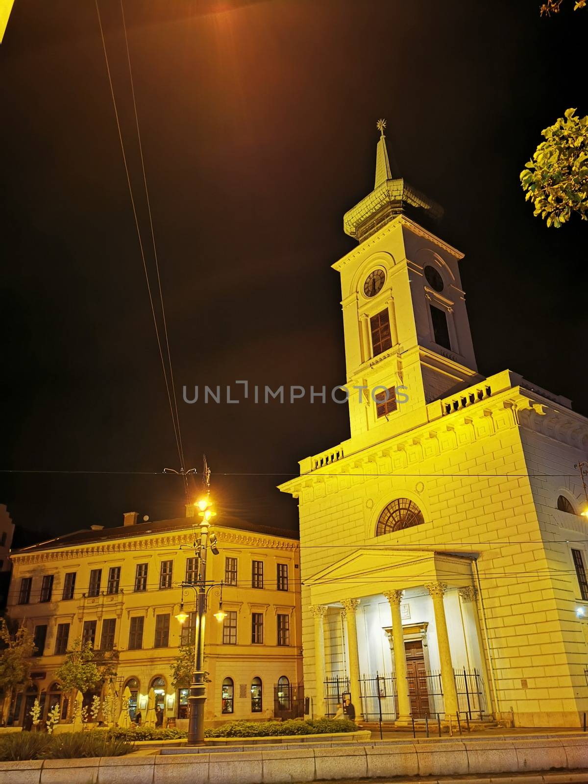 A clock tower in front of a building. High quality photo