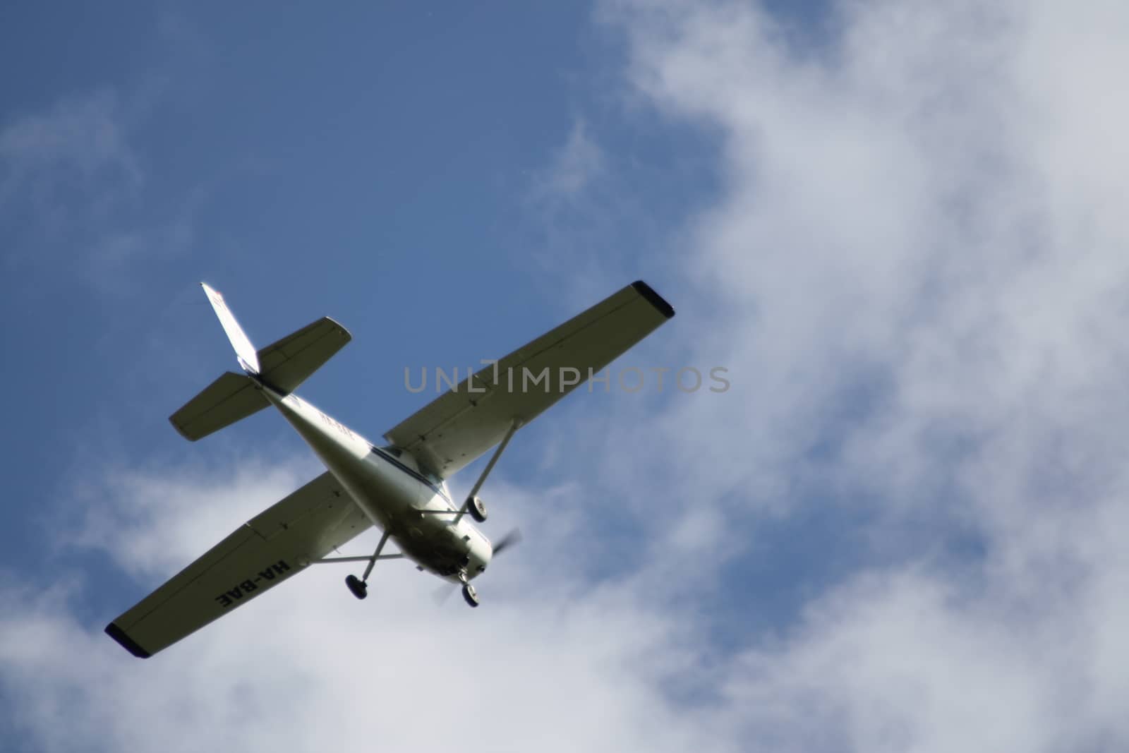 A fighter jet flying through a cloudy blue sky. High quality photo