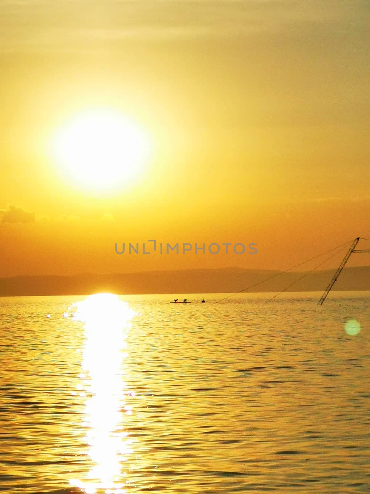 A sunset over a body of water. High quality photo