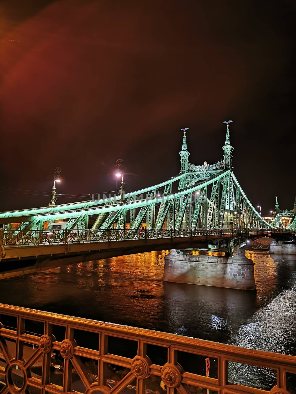 A train crossing a bridge over a body of water. High quality photo