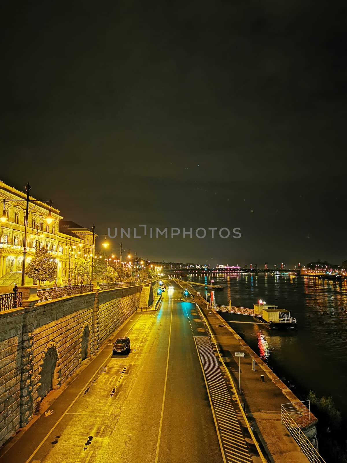 Evening view of The Corvinus University of Budapest with the Danube and the quay by balage941