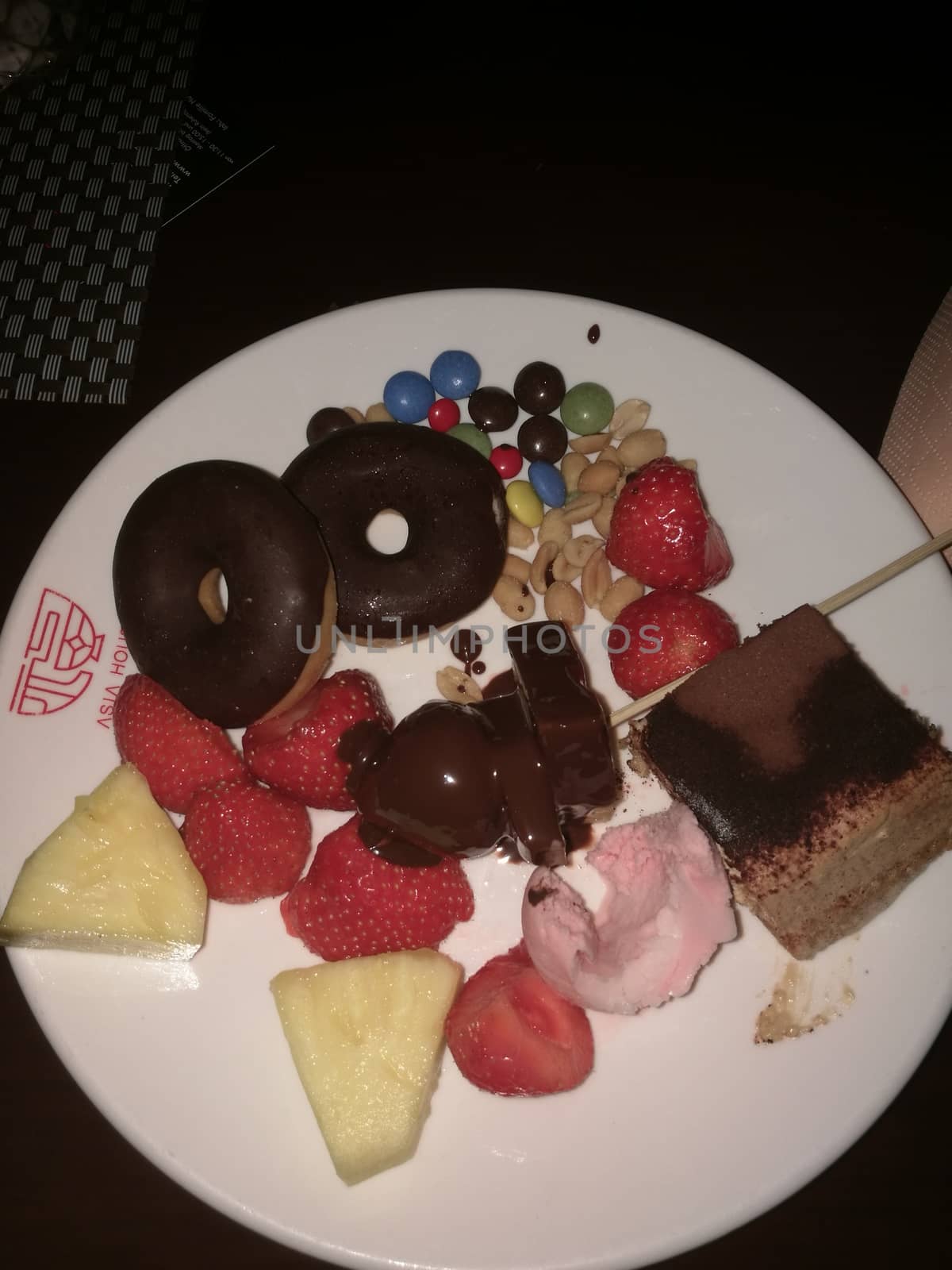 A piece of chocolate cake and fruits on a plate. High quality photo