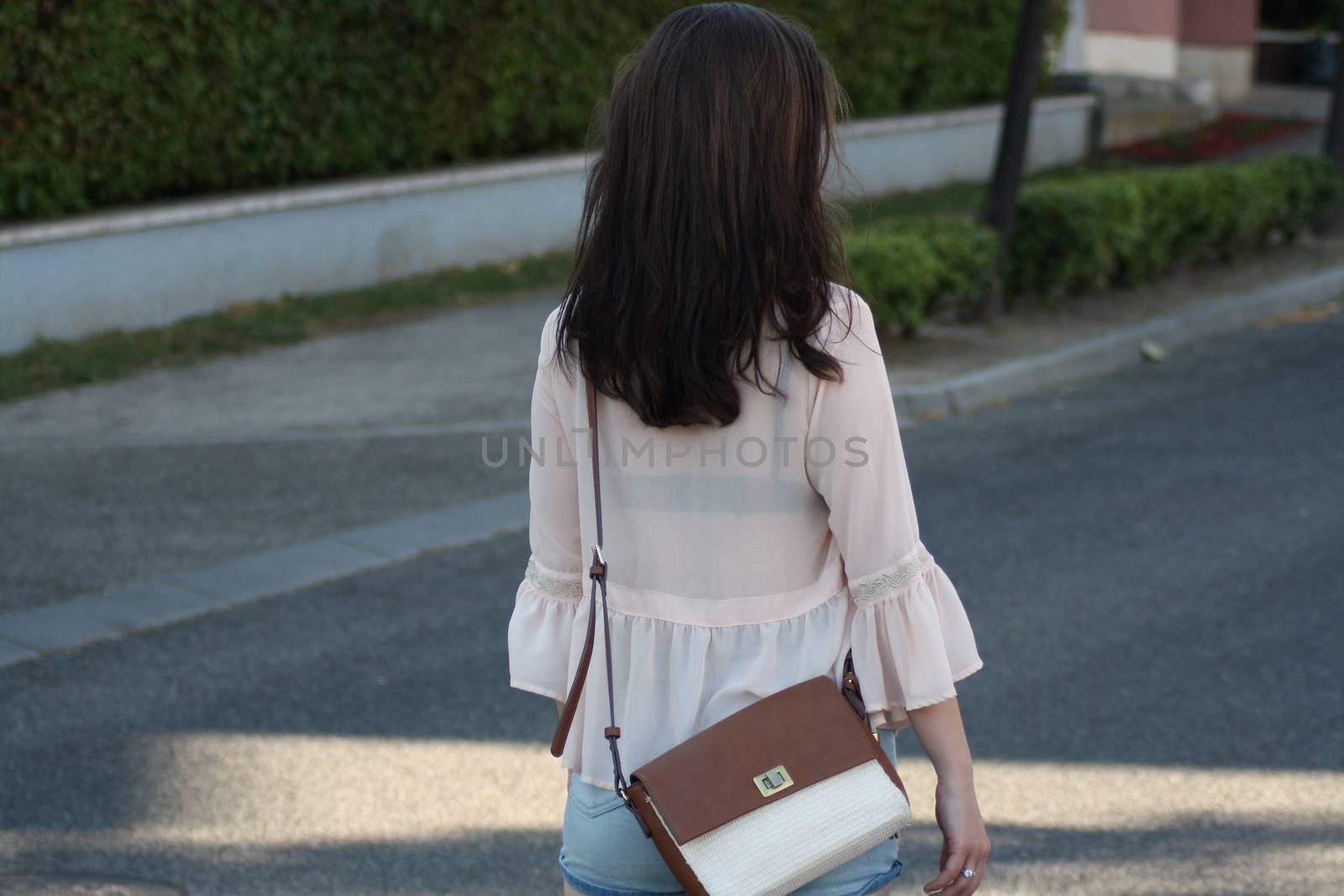 A woman walking down the street. High quality photo