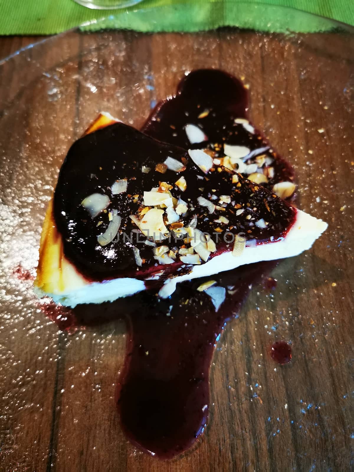 Cheesecake with blueberry sauce and toasted almonds. 