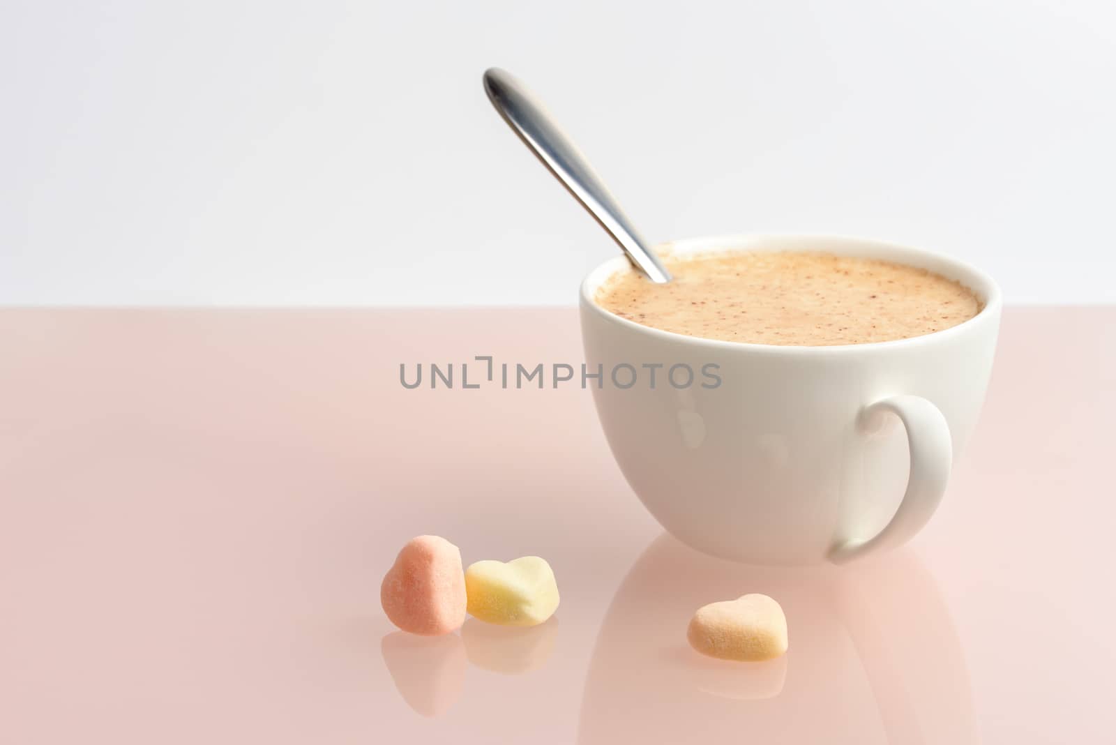 Cup of coffee on the table. Coffee on a pink background,