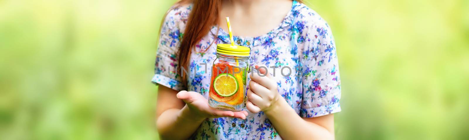 Girl holding jar with juice. Fruit diet. Fruit lemonade in jar.