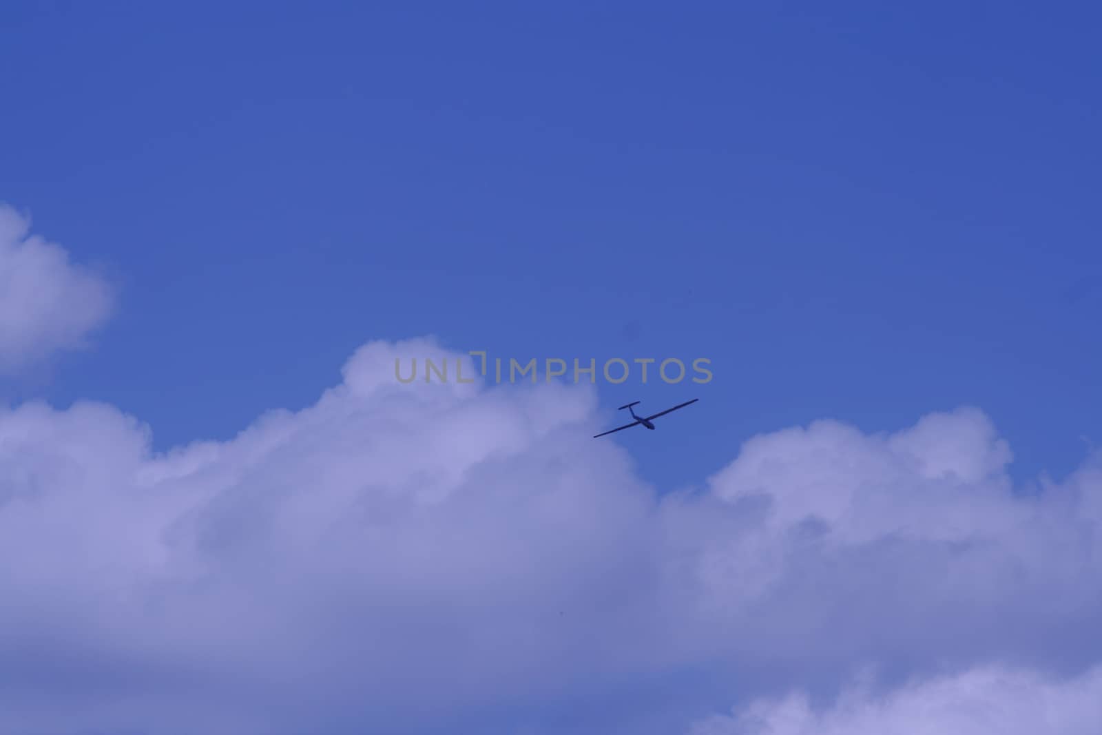 In the clouds, the far away aircraft High quality photo