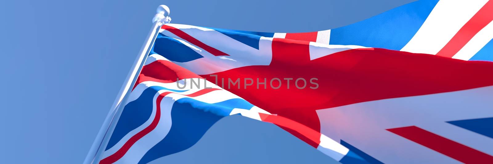 3D rendering of the national flag of British waving in the wind against a blue sky