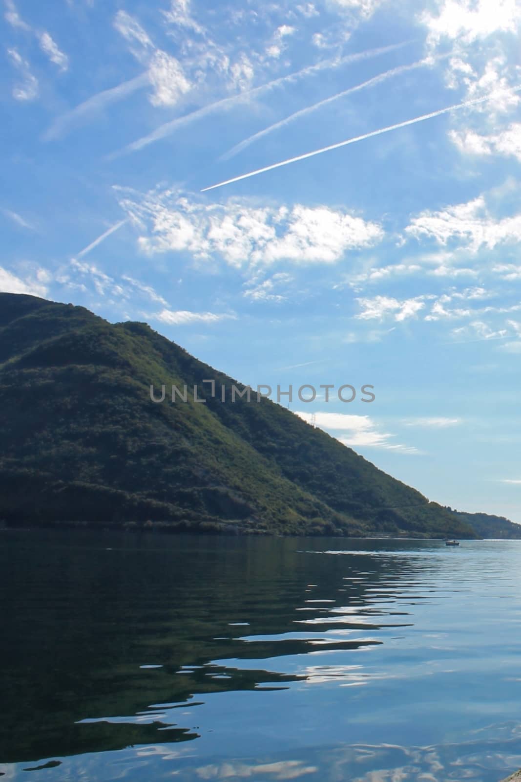 A body of water with a mountain in the background. High quality photo