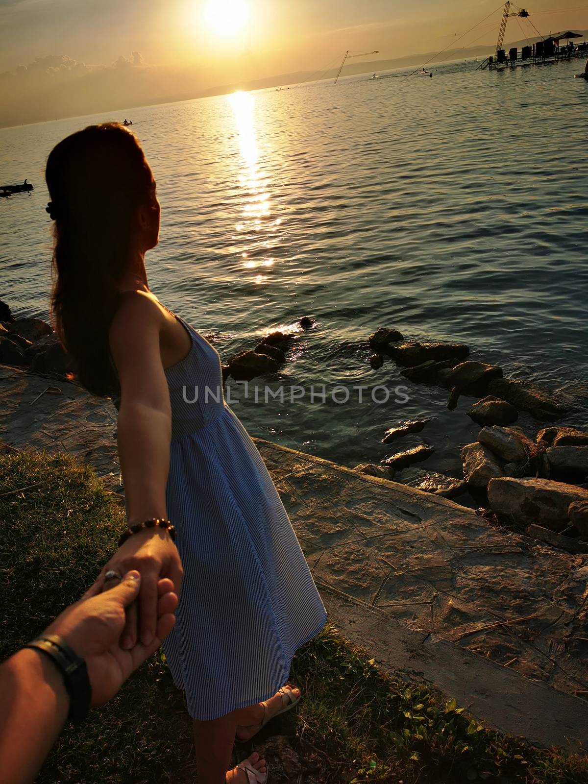 A handshake of a couple in love at lake Balaton by balage941