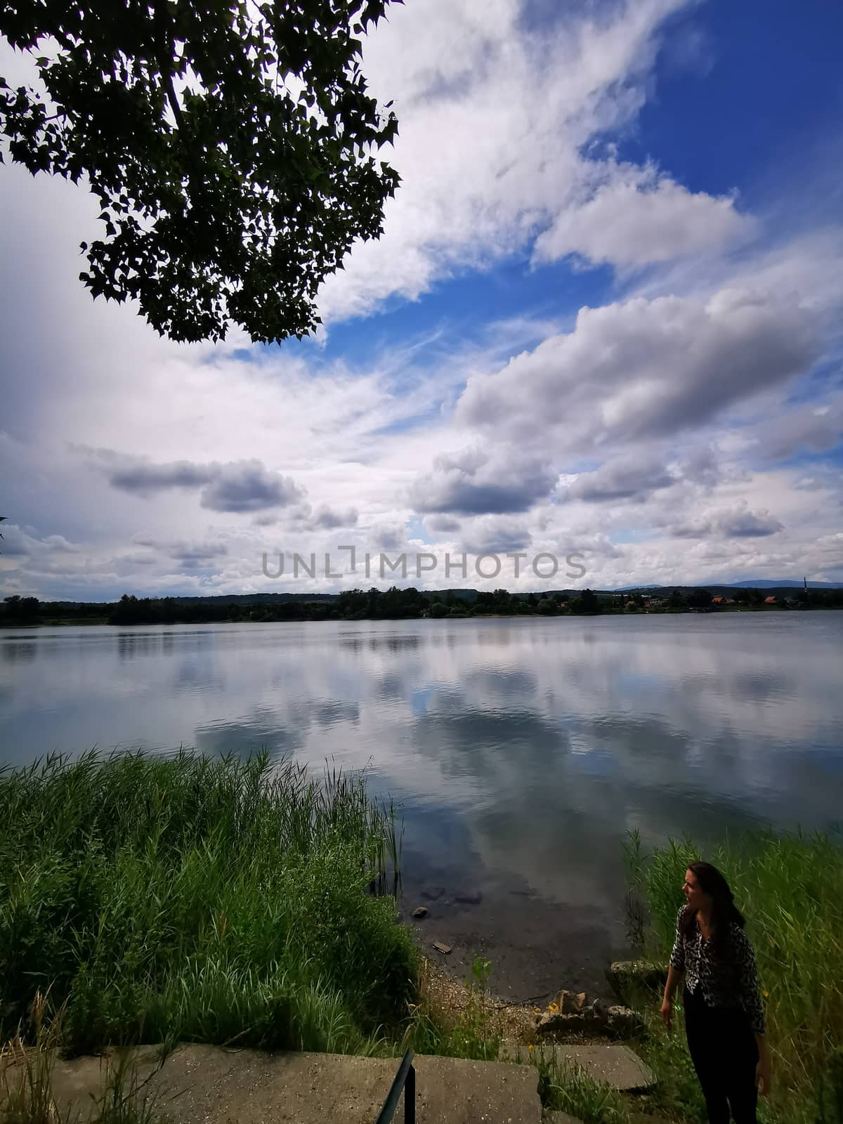 Standing a woman in front of a body of water by balage941