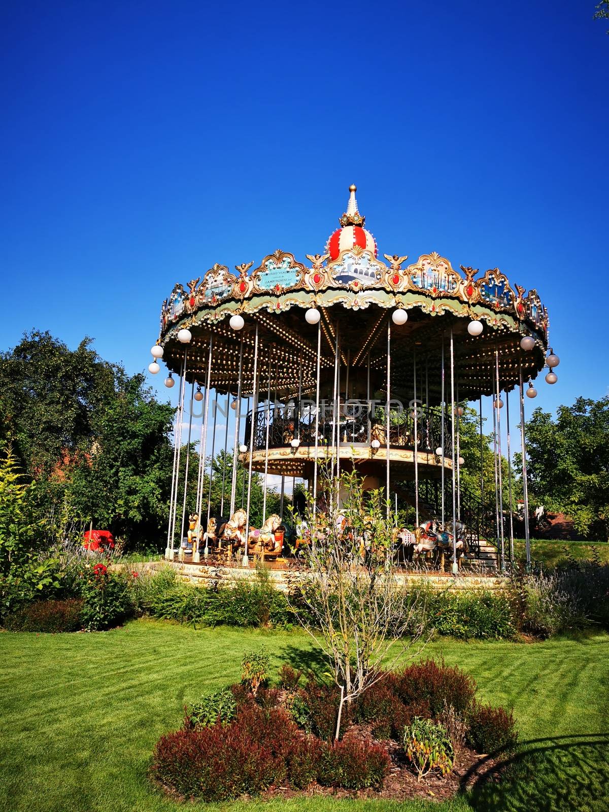A carousel in front of a building. High quality photo