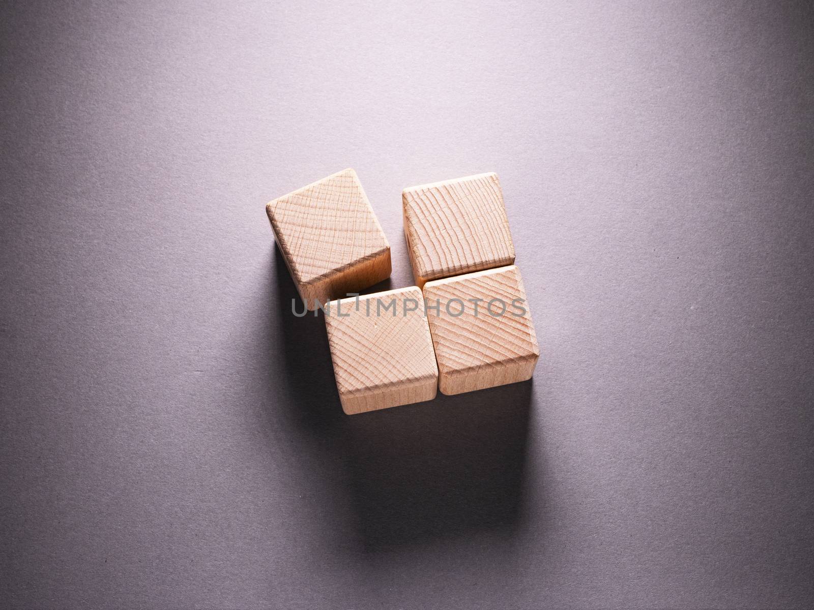 Wooden Geometric Shapes Cube on a paper background , This can use for past your words