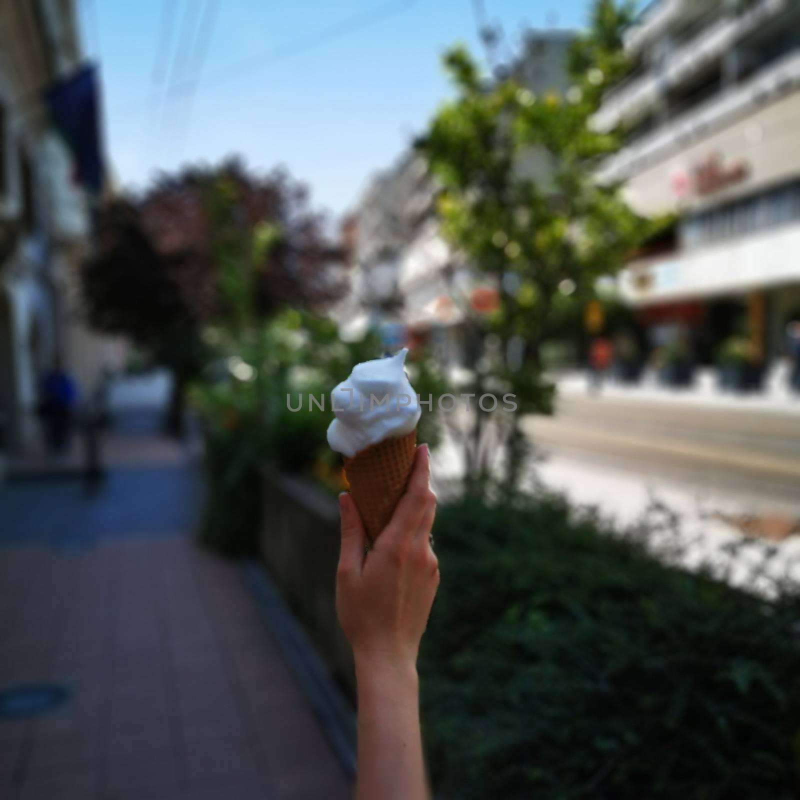 A woman holding a vanilia ice cream. High quality photo