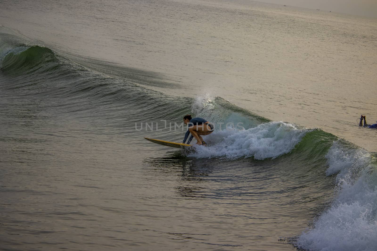 Chennai, Tamilnadu -India . September 2, 2020. A foreign girl swimming in the sea on the waves, surfing