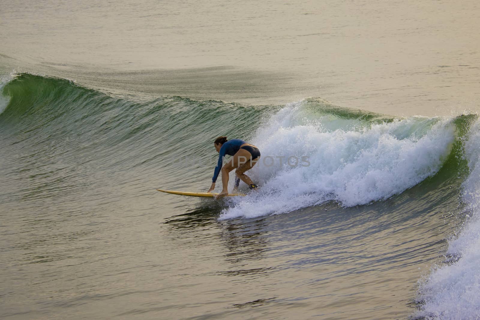 A foreign lady tourists surfing the sea waves by 9500102400