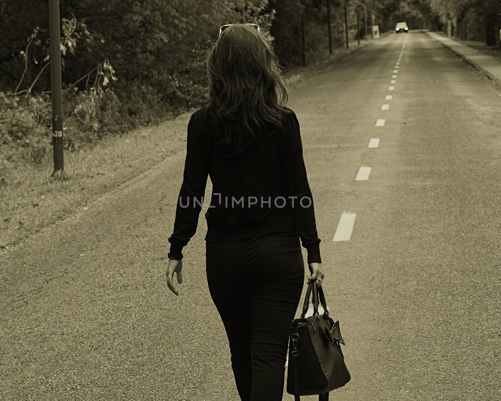 A woman walking down the road. High quality photo