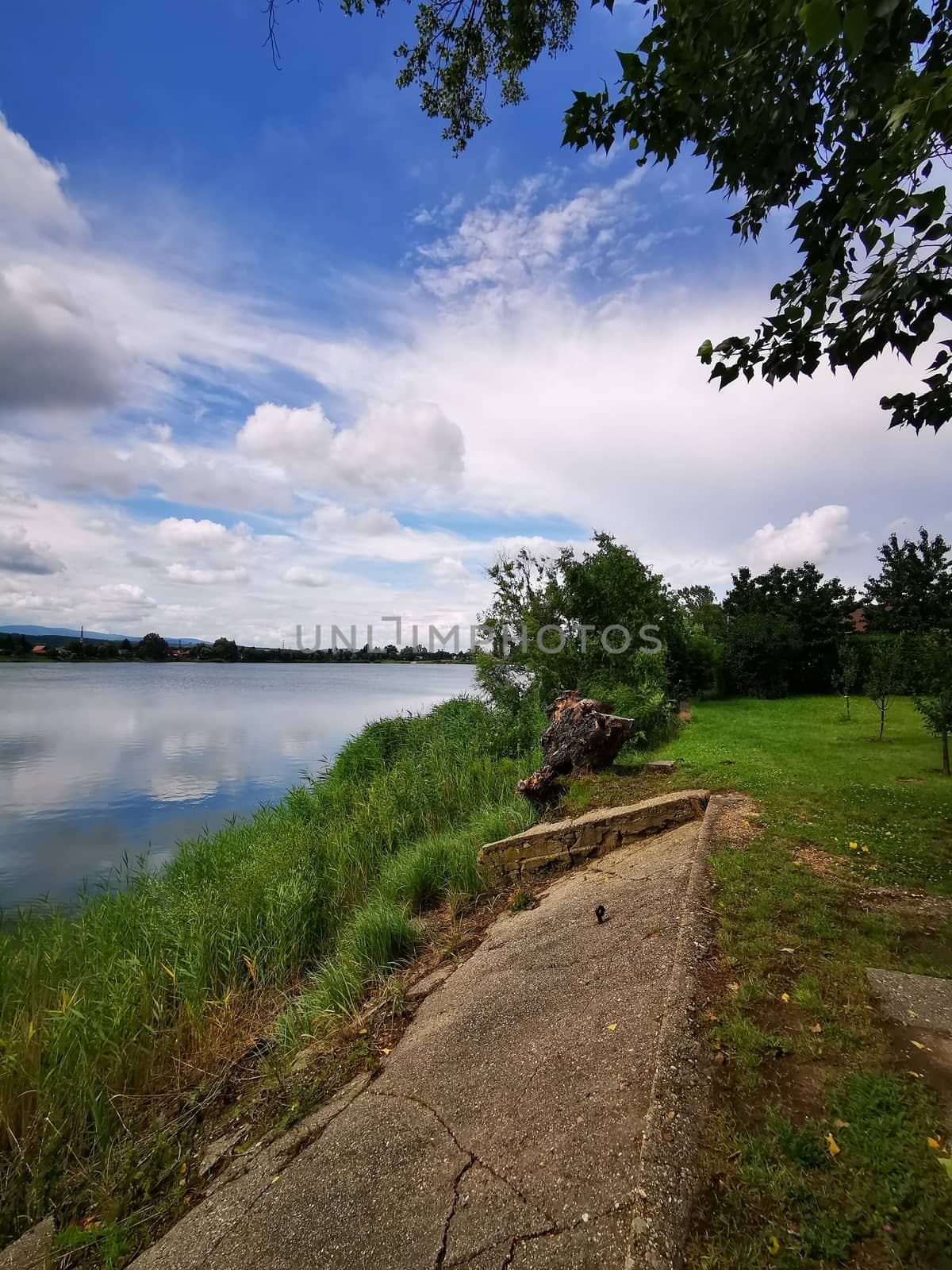 A dirt path next to a body of water. High quality photo