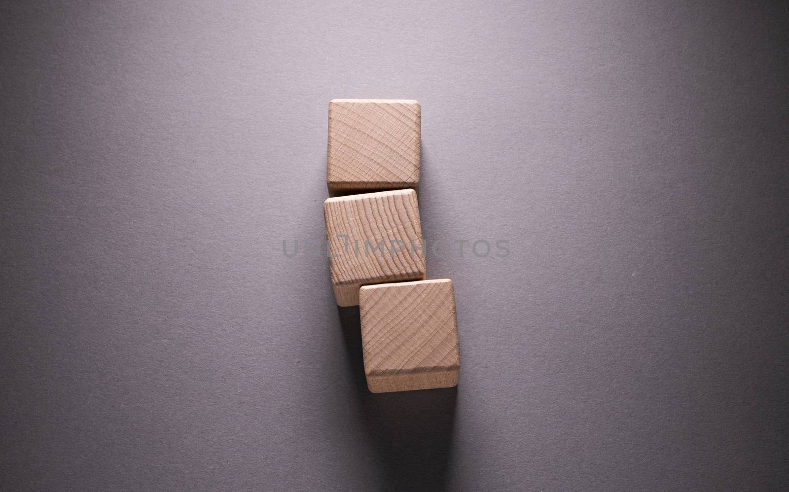 Wooden Geometric Shapes Cube on a paper background , This can use for past your words