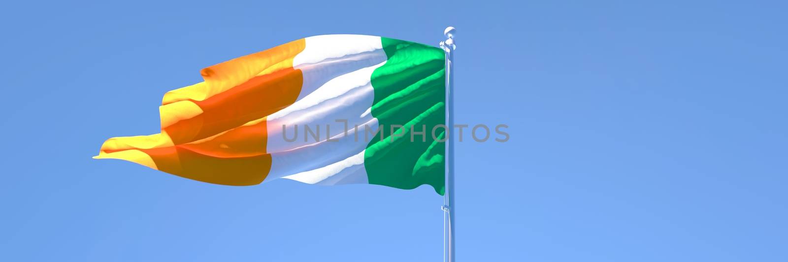 3D rendering of the national flag of Ireland waving in the wind against a blue sky