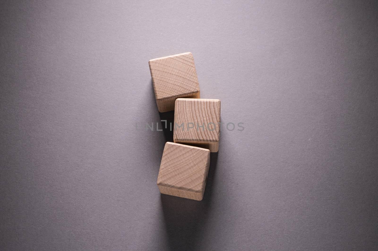 Wooden Geometric Shapes Cube on a paper background , This can use for past your words