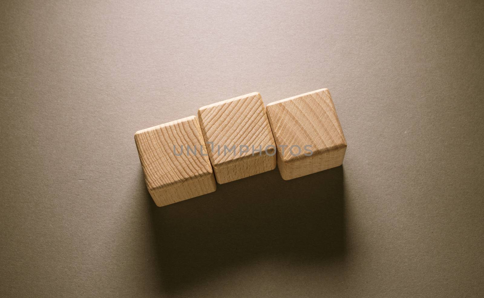 Wooden Geometric Shapes Cube on a paper background , This can use for past your words