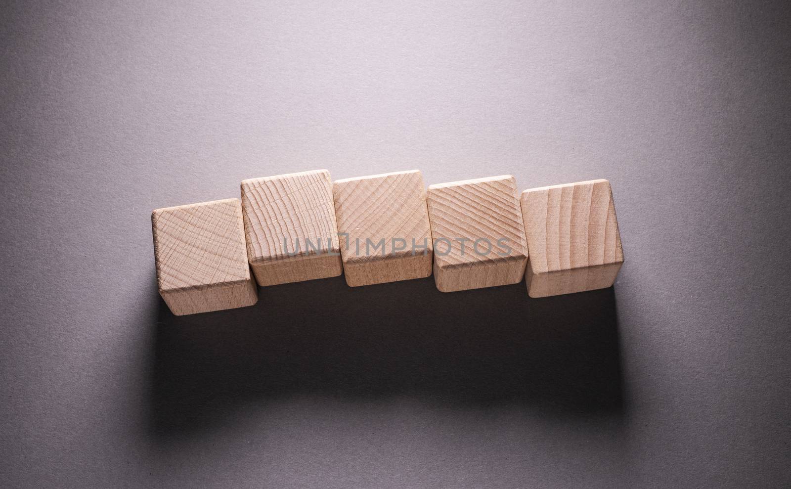 Wooden Geometric Shapes Cube on a paper background , This can use for past your words