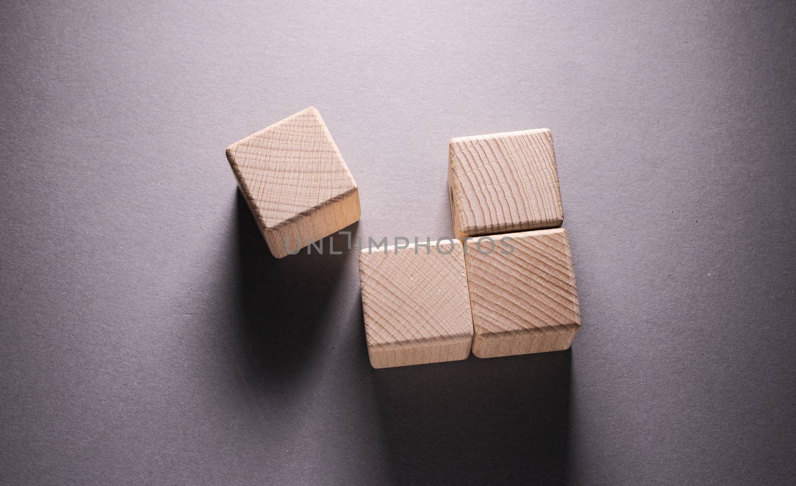 Wooden Geometric Shapes Cube on a paper background , This can use for past your words