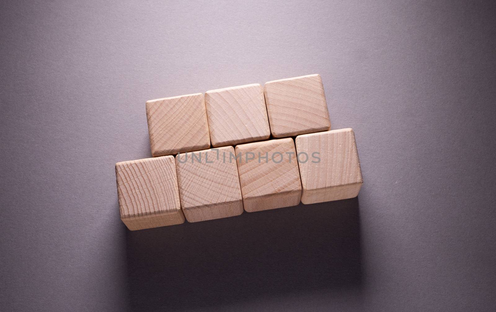 Wooden Geometric Shapes Cube on a paper background , This can use for past your words