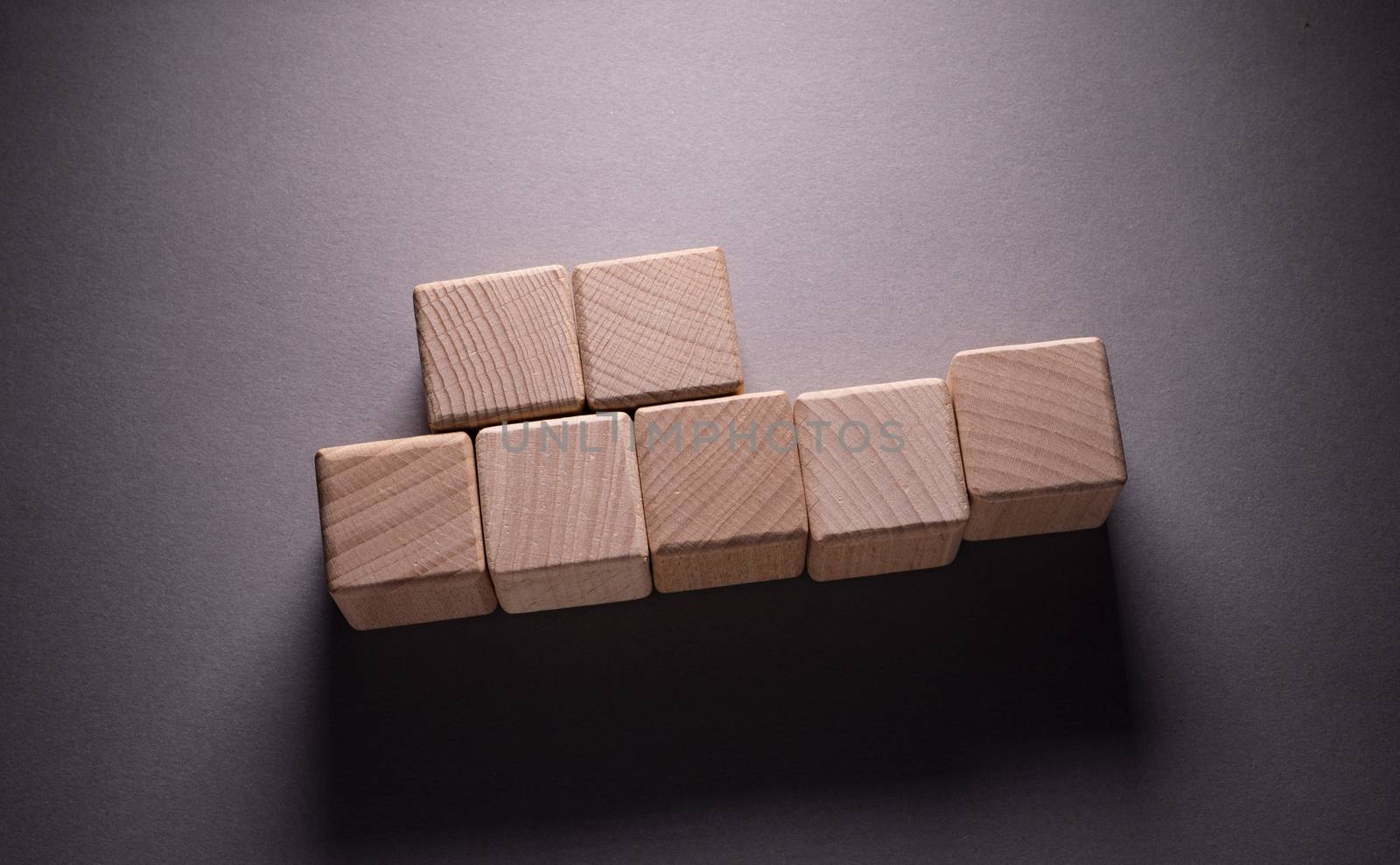 Wooden Geometric Shapes Cube on a paper background , This can use for past your words