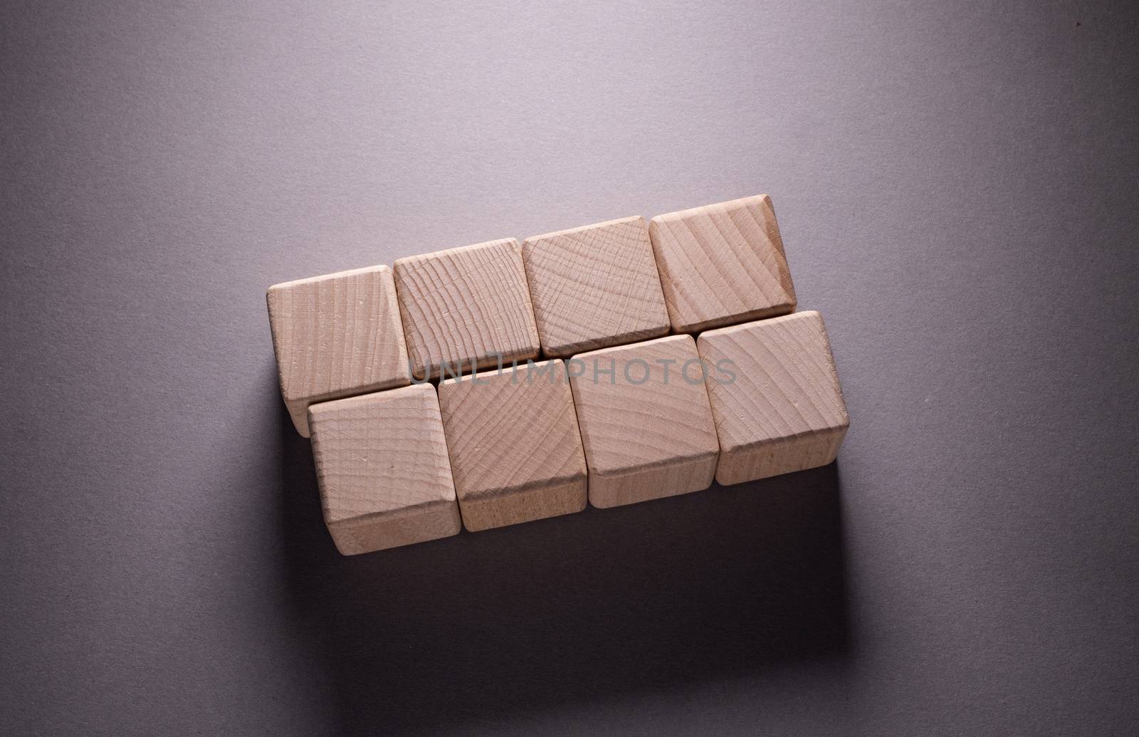 Wooden Geometric Shapes Cube on a paper background , This can use for past your words