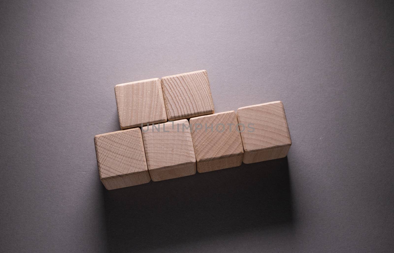 Wooden Geometric Shapes Cube on a paper background , This can use for past your words