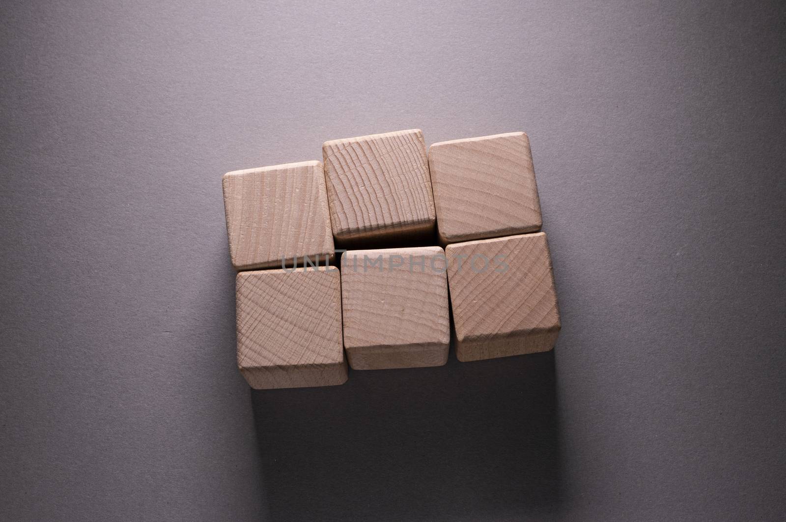 Wooden Geometric Shapes Cube on a paper background , This can use for past your words