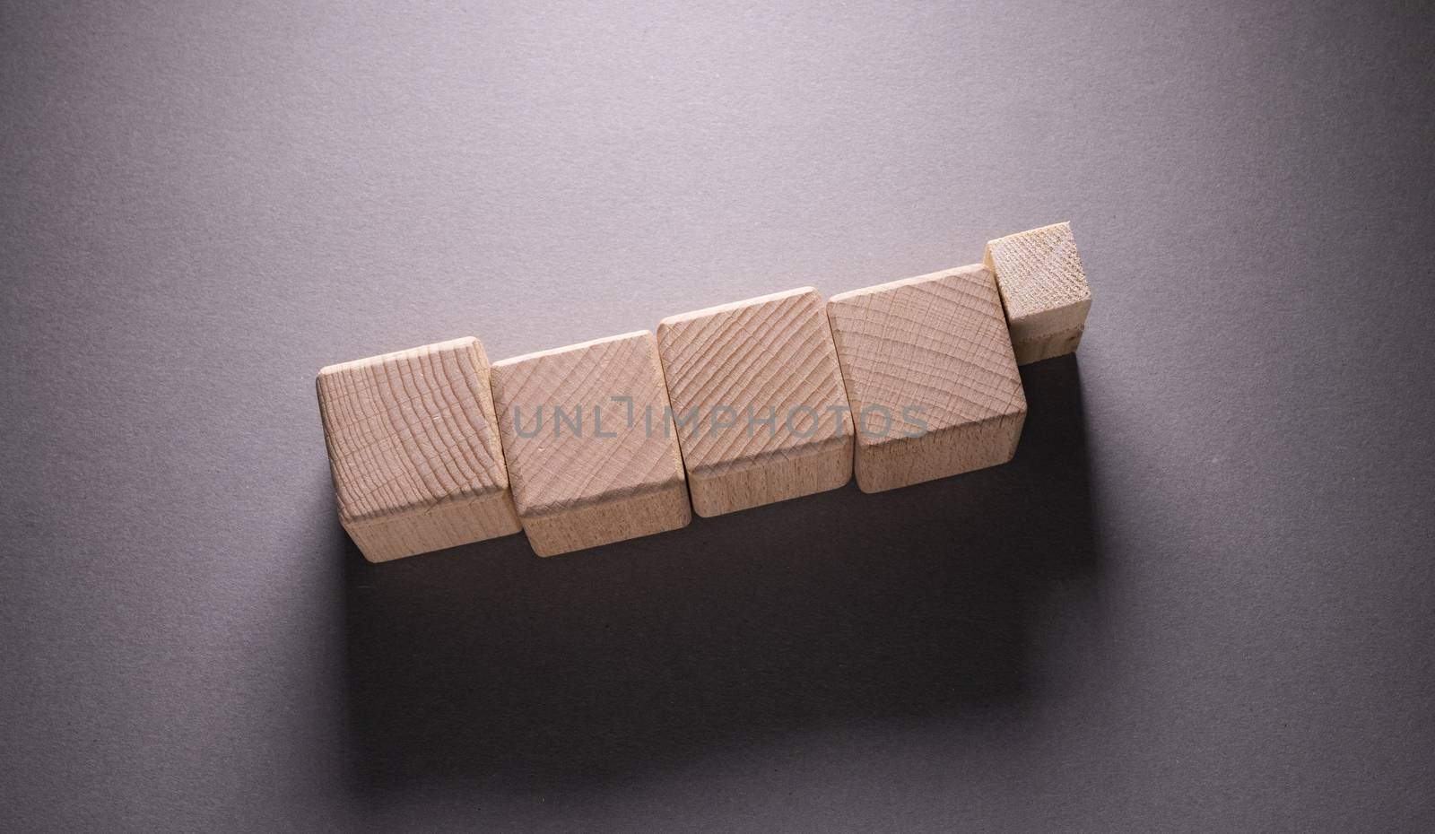 Wooden Geometric Shapes Cube on a paper background , This can use for past your words