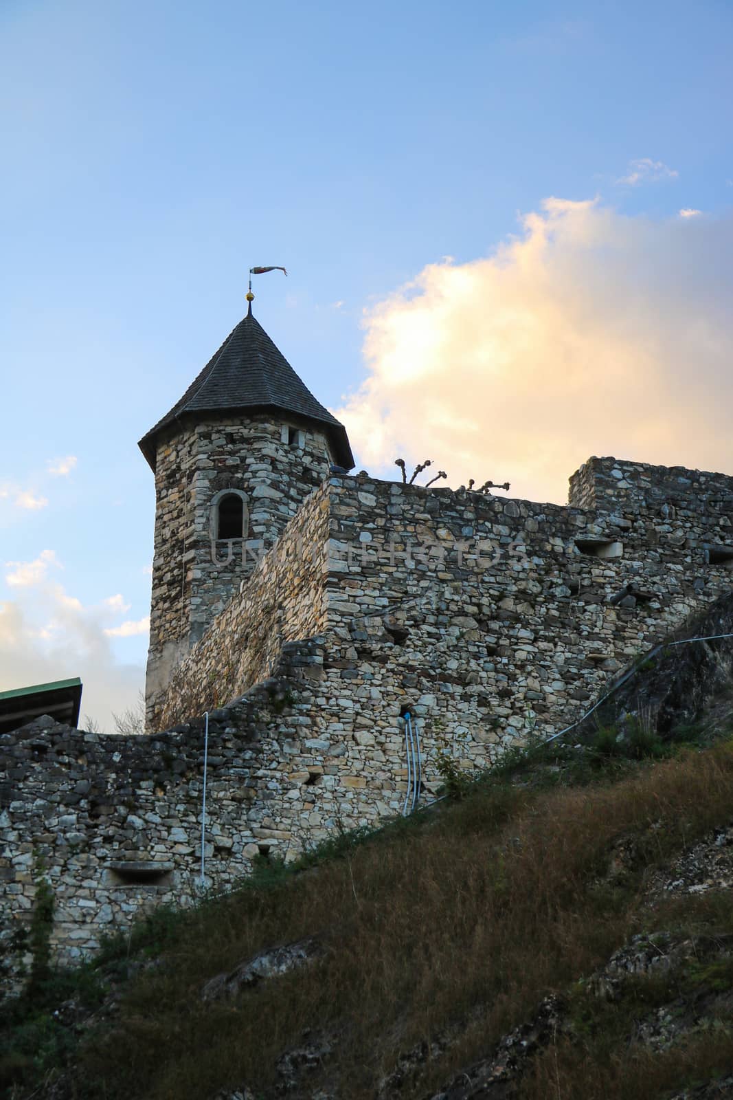 Fragment of an old castle with a stone wall