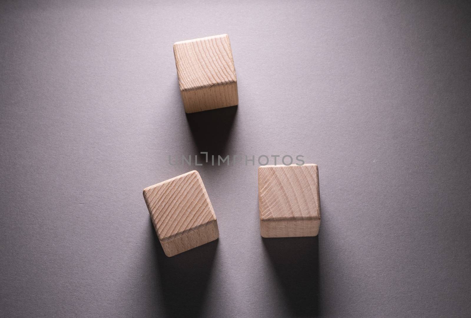 Wooden Geometric Shapes Cube on a paper background , This can use for past your words