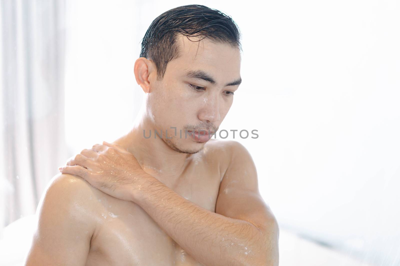 Closeup young man washing hair with with shampoo in the bathroom by pt.pongsak@gmail.com