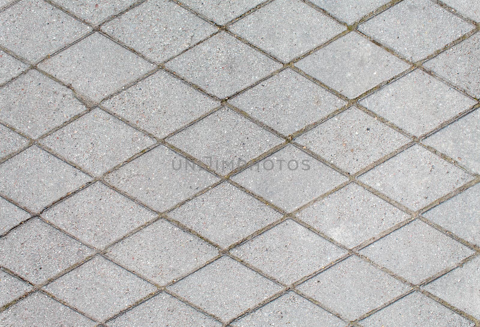 road paved with rhombus sidewalk tiles. beautiful brick background with, masonry texture of light gray bricks. outdoor closeup