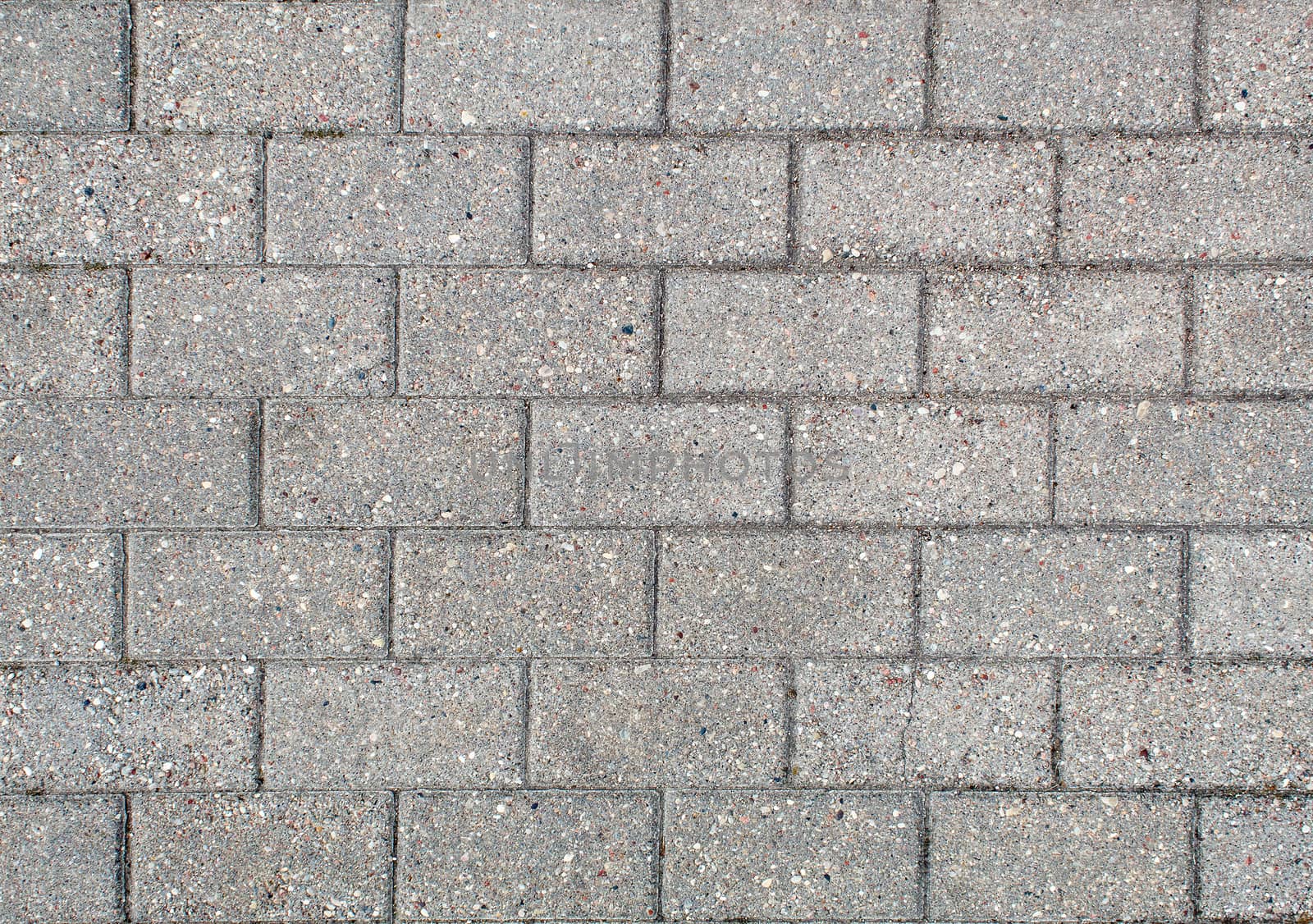 road paved with sidewalk tiles. beautiful brick background with, masonry texture of light gray bricks. outdoor closeup